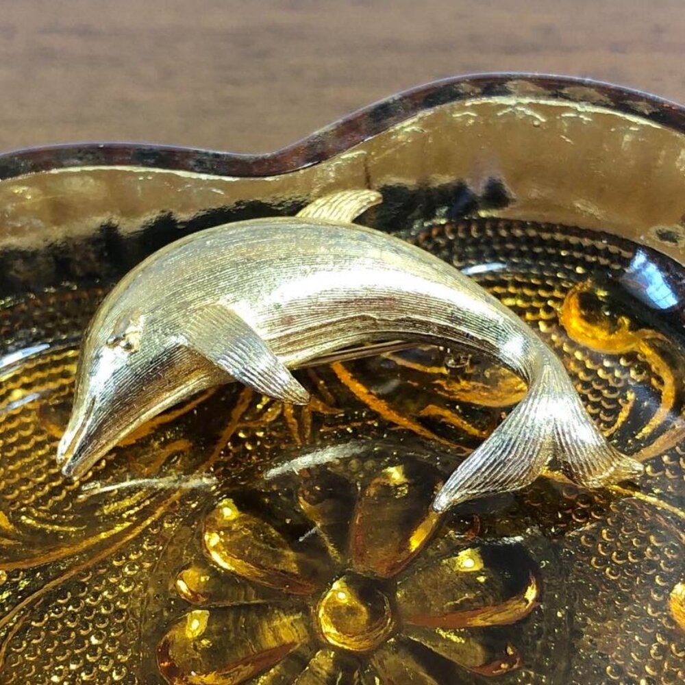 Dolphin gold tone brooch